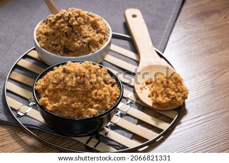Meat floss on a wood grain table Royalty-Free Stock Photo #2066821331