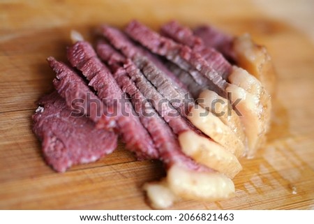 Cooked horse meat on cutting board