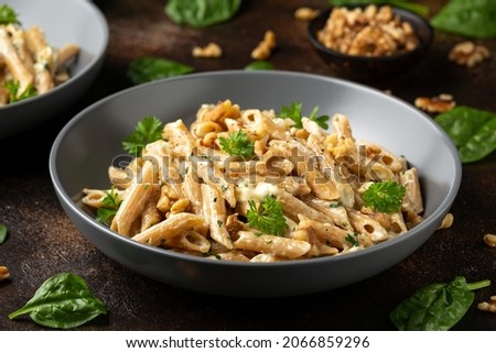 Whole Wheat Penne pasta with gorgonzola cheese sauce, spinach and walnut. Healthy food. Royalty-Free Stock Photo #2066859296
