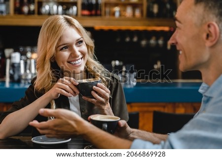 Bonding relationship. Interested excited falling in love mature woman listening to her husband man boyfriend while drinking coffee in restaurant cafe on a date Royalty-Free Stock Photo #2066869928