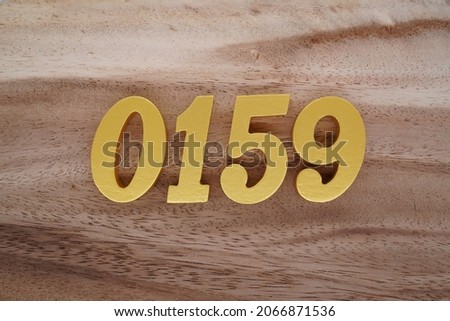 Golden Arabic numerals 0159 on a dark brown to white wood grain background.