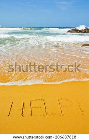 Help! - written in sand on the beach
