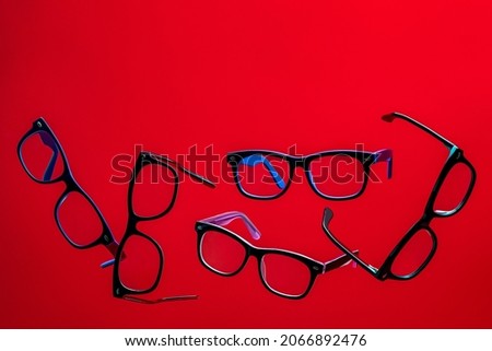 Glasses shot on a red background in the air.