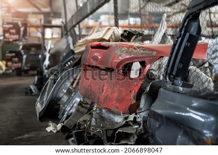 Heap of old rusty disassembled car parts at workshop waste storage hangar indoor. Vehicle salvage dismantling garage. Iron auto spare details trunk pile for recycling at scrap junkyard Royalty-Free Stock Photo #2066898047