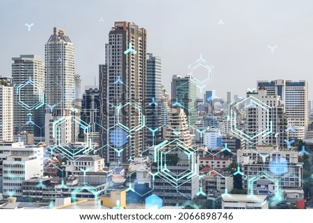 Technology hologram over panorama city view of Bangkok. The largest tech hub in Southeast Asia. The concept of developing coding and high-tech science. Double exposure.