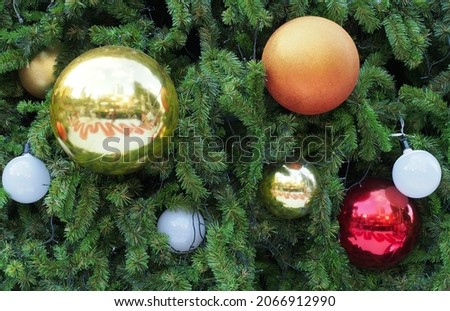 group of colorful shiny plastic christmas ball and sphere white light bulb hanging on artificial christmas tree, bauble ornament for christmas night party decoration, xmas banner