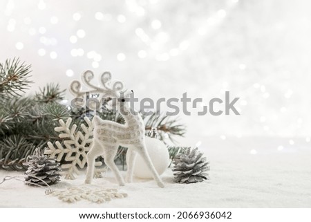 Christmas card with a deer and Christmas decorations. Copy space.