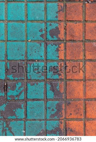 orange and green painted asphalt concrete sidewalk texture from Paris streets