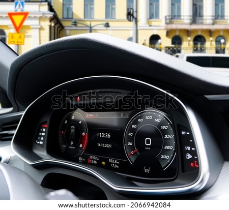 Close up shot of a fully digital dashboard. Car digital dashboard. Dashboard details with indication lamps. Car instrument panel. Modern car interior details.