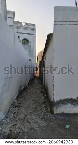 Alley way between two house with new cemented path.