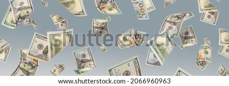 One hundred dollar bills are falling against a blue background. The concept of wealth, big wins or huge income. Space to copy space or paste text