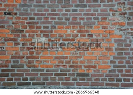 Weathered red and brown brick wall Royalty-Free Stock Photo #2066966348