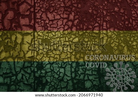 flag of bolivia on a old vintage metal rusty cracked wall with text coronavirus, covid, and virus picture.