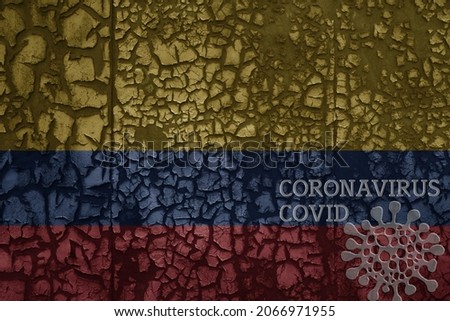 flag of colombia on a old vintage metal rusty cracked wall with text coronavirus, covid, and virus picture.