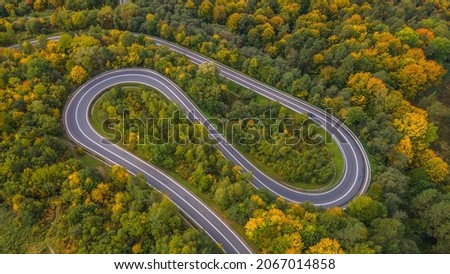 Picturesque winding road running through the autumn colorful forest, Przysłup Pass in the Slonne Mountains 