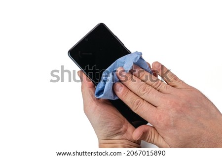 View of male hands holding mobile phone during sanitizing isolated on white background. Health concept. Attention coronavirus. Sweden.