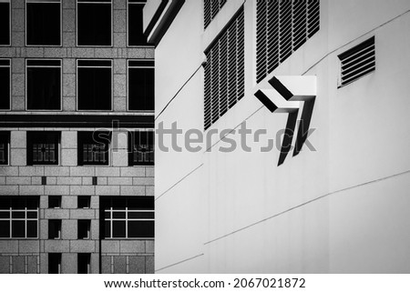 Air vents in side of commercial building with geometric window pattern and negative space for copy