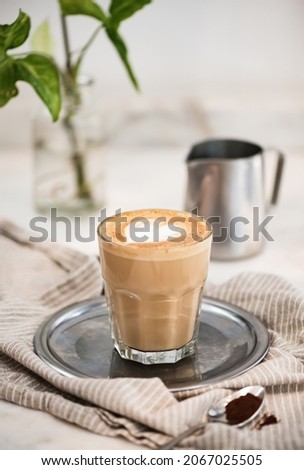 Flat white coffee with heart shaped milk and coffee powder Royalty-Free Stock Photo #2067025505