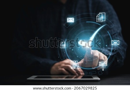 Businessman holding tablet with virtual document and mark correct sign for online approve  paperless and quality assurance concept. Royalty-Free Stock Photo #2067029825