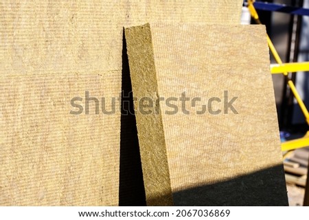 Thermal insulation material, rock wool. Thermal roof insulation layer. Mineral wool or mineral fiber, mineral cotton, mineral fibre, glass wool, MMMF, MMVF. Fiber thermal insulation close-up. Royalty-Free Stock Photo #2067036869