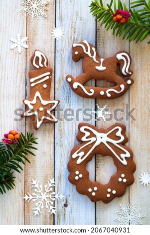 Top view of gingerbread cookies on wooden background
