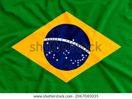 Brazil flag on wavy fabric. Translation: order and progress. Brazilian flag day Royalty-Free Stock Photo #2067045035