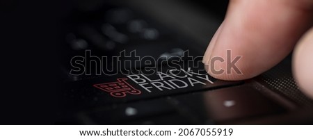 Close up,finger pressed down on black friday notebook computer keyboard. concept confirm product order or agreement
