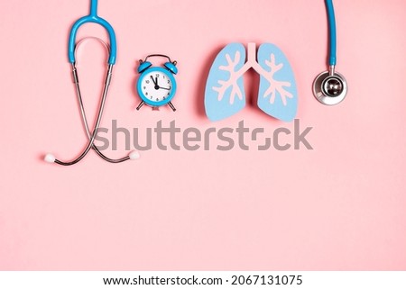 Prevention of pulmonary disease. Lung symbol, stethoscope and alarm clock on a pink background. Healthcare and medicine concept.  Royalty-Free Stock Photo #2067131075