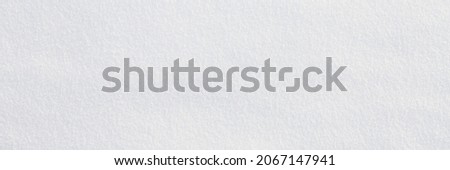 Natural snow texture. Smooth surface of clean fresh snow. Snowy ground. Winter background with snow patterns. Closeup top view. Wide panoramic texture for background and design. Royalty-Free Stock Photo #2067147941