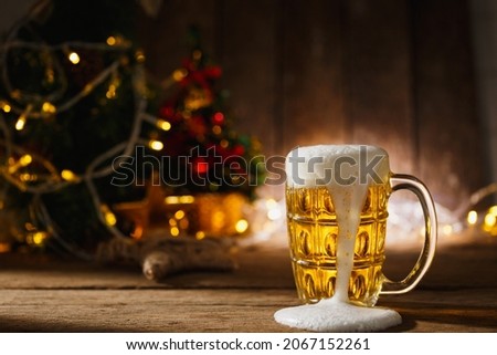 Beer in mug on wooden table with Christmas lighting background