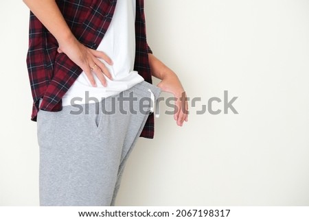 A guy peeking his genital inside pants Royalty-Free Stock Photo #2067198317
