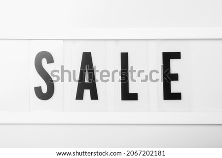 Lightbox with word Sale as background, closeup. Black Friday