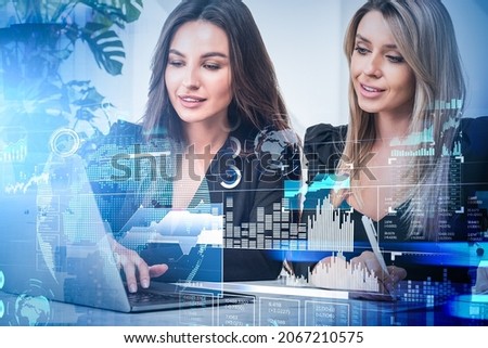 Two office women work together with device in office room. Digital hud earth globe with stock market changes, forex data information, symbols and circuit. Concept of data storage
