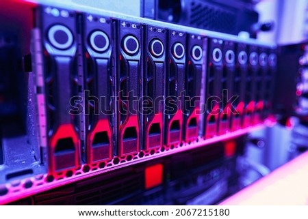 Up-to-date rack-mounted illuminated computer hardware in data center Royalty-Free Stock Photo #2067215180