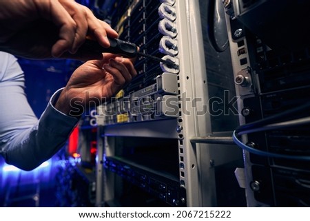 Engineer installing network equipment in data center Royalty-Free Stock Photo #2067215222