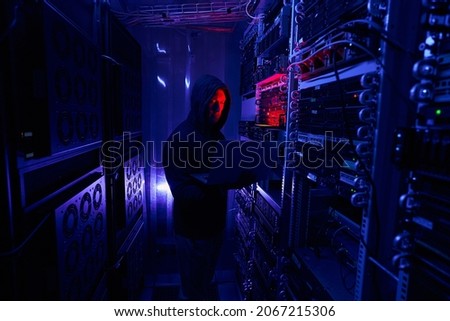 Professional cybercriminal breaking into information security system Royalty-Free Stock Photo #2067215306