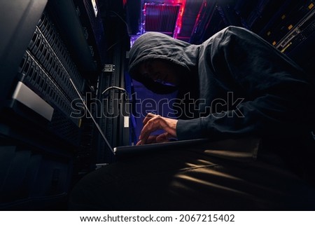Cybercriminal attempting to hack computer network security system Royalty-Free Stock Photo #2067215402