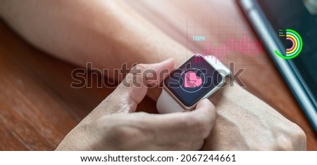 Close-up of a smart watch health tracker with the heart rate shown on the screen. Modern stylish and innovation wearable device Royalty-Free Stock Photo #2067244661