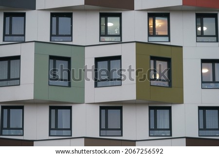 Texture, design and right geometry of new modern residetial building exterior in the city Moscow in autumn day. Modern construction. Close up photography. green colors in the design