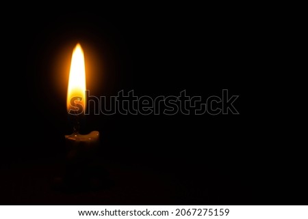Close up single candle light and flame on black background, Candle light composition different rituals