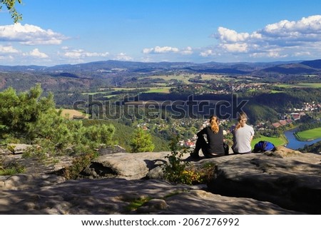 Hiker enjoys the view from Lilienstein to the river Elbe and Bad Schandau, Saxon Switzerland - Germany Royalty-Free Stock Photo #2067276992