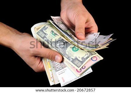 Money in the hands isolated on black background