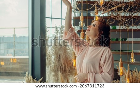 The girl holds a light bulb in her hand. Festive mood. Close-up