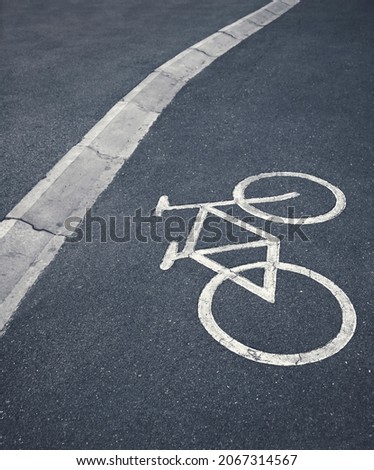 Bicycle lane sign separating city pedestrians. Exercise in urban parks.