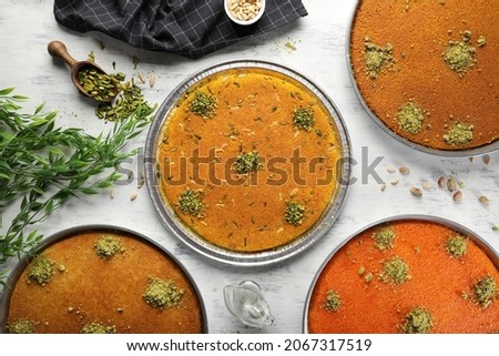 Arabic traditional mix kunafa. desserts rough and soft konafa in trays sweet with pistachio and pine on top. top view Royalty-Free Stock Photo #2067317519