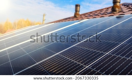 Close-up of Solar energy panel photovoltaic module on the roof of modern house. Closeup of Solar Panels with sunlight Royalty-Free Stock Photo #2067330335