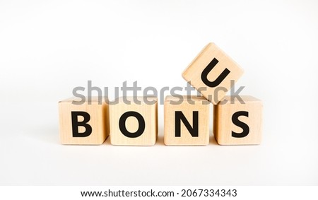 Bonus symbol. The concept word 'bonus' on wooden cubes. Beautiful white table, white background. Business and bonus concept. Copy space.