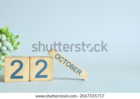 October 22, Calendar cover design with number cube with green fruit on blue background.