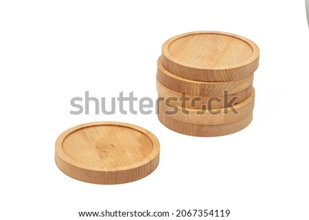 Round wooden coasters isolated above white background. Royalty-Free Stock Photo #2067354119