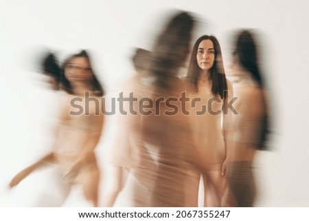 The girl got lost in the crowd. Black and white photo of a girl in underwear. One person in focus. The crowd is in a hurry on business